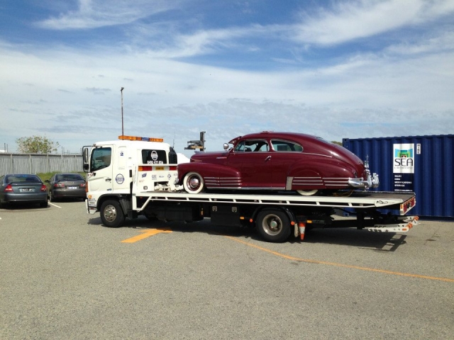 classic buick being towed on a tilt tray in Perth