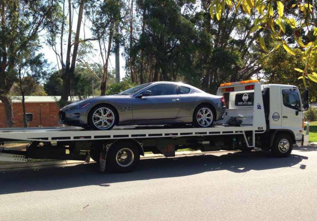 silver sports car on a tilt tray truck in western australia